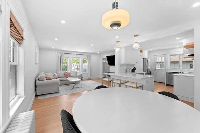 633 Lagrange St, Boston, MA 02132 - dining room featuring radiator, recessed lighting, light wood finished floors, and baseboards