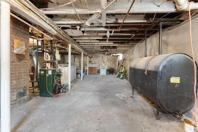 633 Lagrange St, Boston, MA 02132 - unfinished basement with heating fuel, a heating unit, and washer / clothes dryer