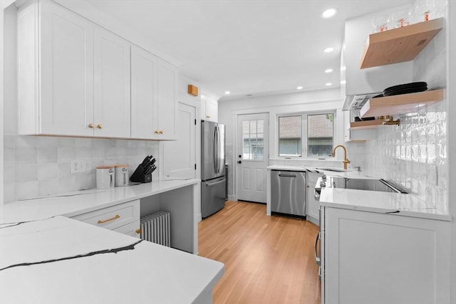 633 Lagrange St, Boston, MA 02132 - kitchen with open shelves, appliances with stainless steel finishes, radiator heating unit, recessed lighting, and white cabinets