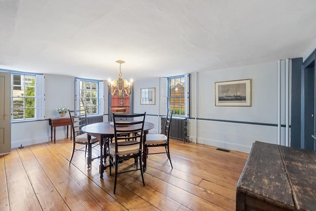 6 Lee St, Marblehead, MA 01945 - dining room with a chandelier, light wood-type flooring, and baseboards