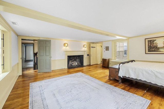 6 Lee St, Marblehead, MA 01945 - bedroom featuring wood finished floors, a fireplace with flush hearth, wainscoting, and crown molding