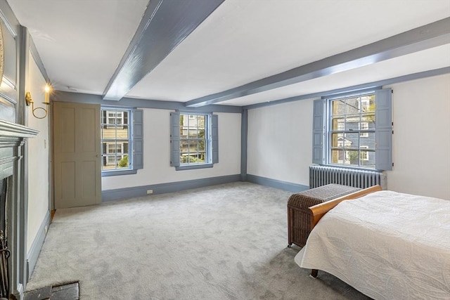 6 Lee St, Marblehead, MA 01945 - bedroom with radiator heating unit, carpet flooring, beam ceiling, a fireplace, and baseboards