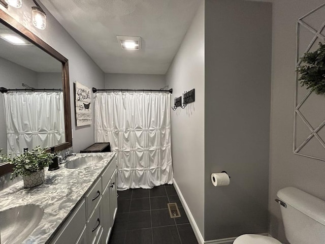 16 Jaclyns Way Unit 16, Billerica, MA 01862 - bathroom featuring toilet, tile patterned flooring, baseboards, double vanity, and curtained shower