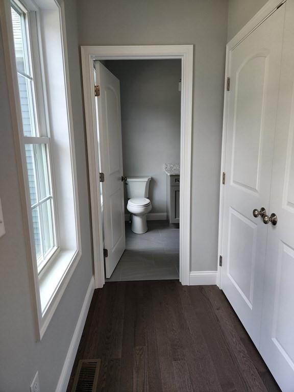 138 Elm St, Uxbridge, MA 01569 - bathroom with toilet, baseboards, wood finished floors, and plenty of natural light