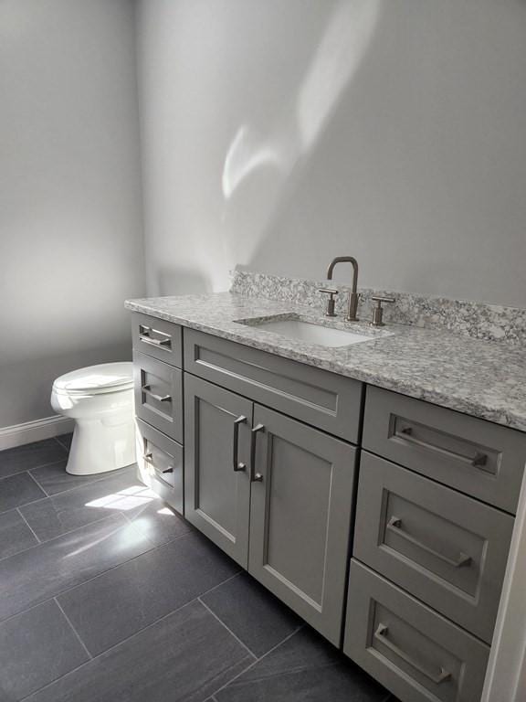 138 Elm St, Uxbridge, MA 01569 - bathroom featuring vanity, baseboards, toilet, and tile patterned flooring
