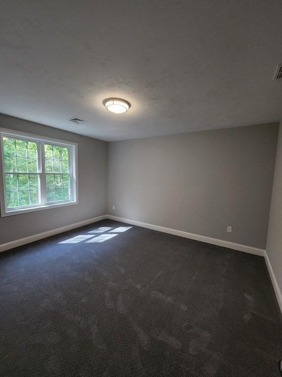 138 Elm St, Uxbridge, MA 01569 - unfurnished room with baseboards and dark colored carpet