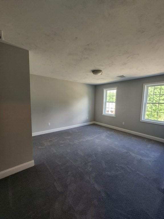 138 Elm St, Uxbridge, MA 01569 - spare room with baseboards and dark colored carpet