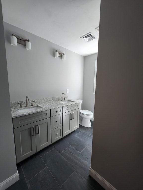 138 Elm St, Uxbridge, MA 01569 - bathroom with toilet, double vanity, and tile patterned floors