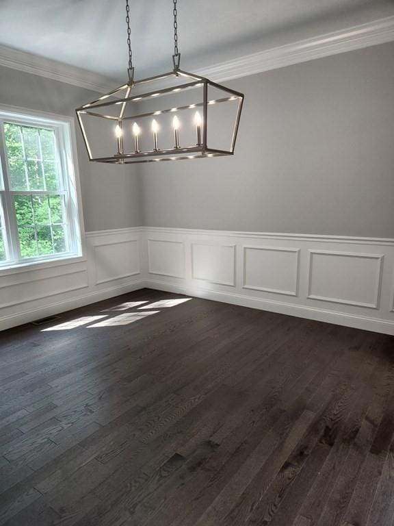 138 Elm St, Uxbridge, MA 01569 - unfurnished dining area with ornamental molding, a chandelier, dark wood finished floors, a wainscoted wall, and a decorative wall