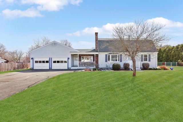 view of front of house featuring fence, a front lawn, driveway, a porch, and a garage