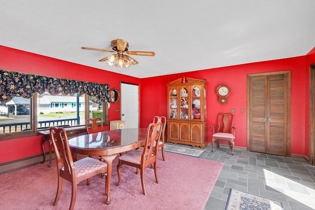 dining area featuring a baseboard radiator, baseboards, and a ceiling fan