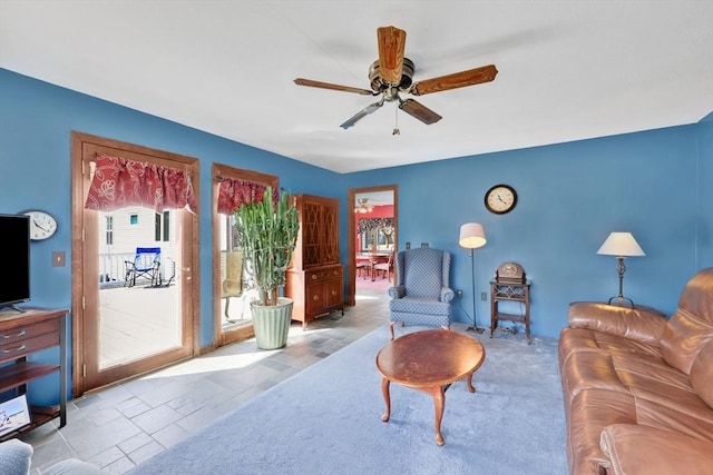 living area featuring a ceiling fan