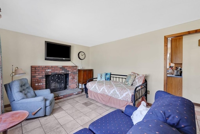 bedroom featuring a brick fireplace and light tile patterned floors
