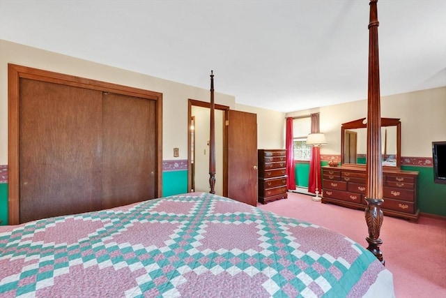 bedroom with baseboard heating, carpet flooring, and a closet