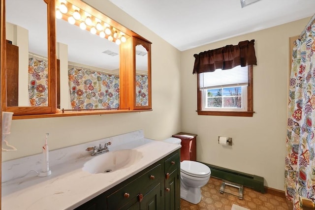 bathroom with baseboard heating, vanity, baseboards, toilet, and visible vents
