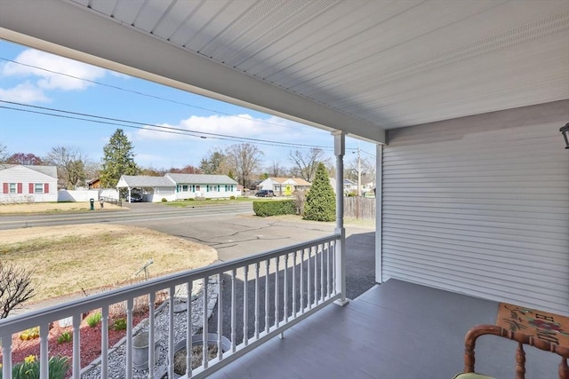 balcony featuring a residential view and covered porch
