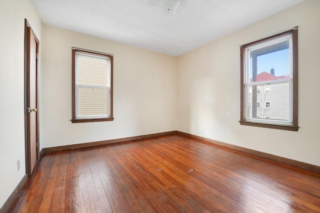 spare room with dark wood-type flooring