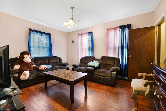 living room with dark hardwood / wood-style floors and a notable chandelier