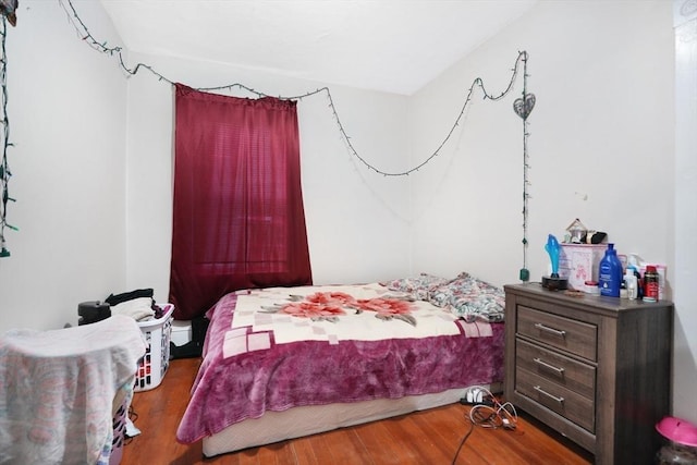 bedroom with hardwood / wood-style flooring