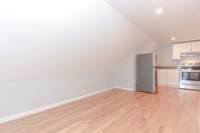 kitchen featuring white cabinetry, appliances with stainless steel finishes, vaulted ceiling, and light hardwood / wood-style floors