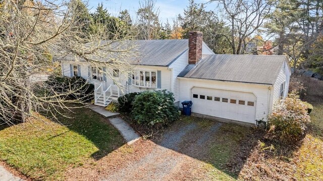 exterior space with a garage and a front lawn