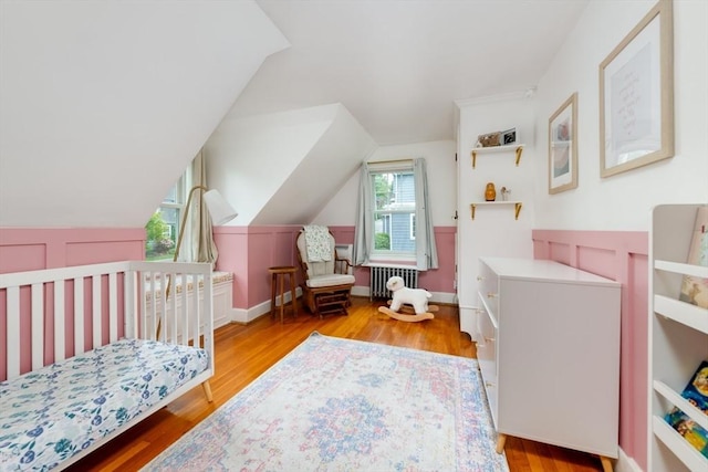 136 Walnut St, Braintree, MA 02184 - bedroom featuring radiator, wood finished floors, and vaulted ceiling