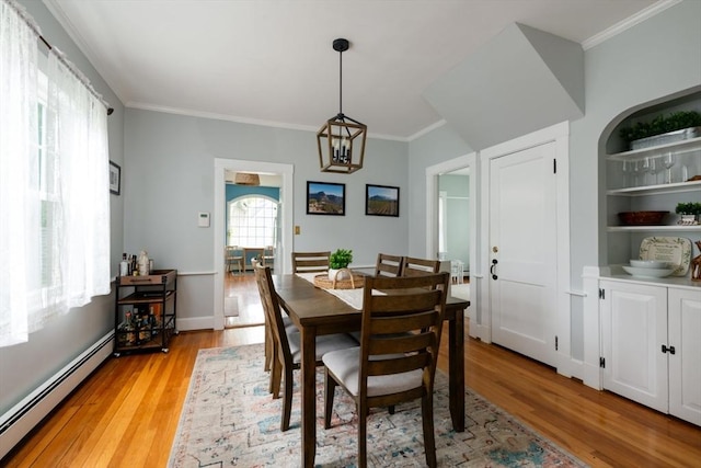 136 Walnut St, Braintree, MA 02184 - dining room with a baseboard heating unit, light wood-style flooring, and crown molding