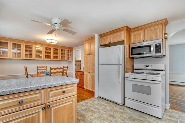 7 Burton Ave, Harwich, MA 02671 - kitchen featuring white appliances, a ceiling fan, arched walkways, light countertops, and glass insert cabinets