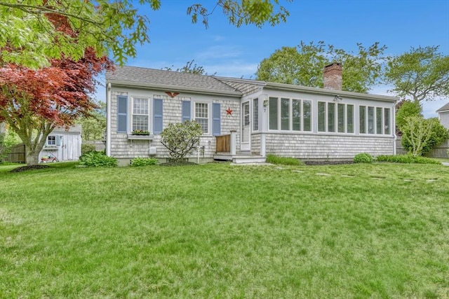 7 Burton Ave, Harwich, MA 02671 - view of front of home featuring a chimney, a front lawn, and a sunroom