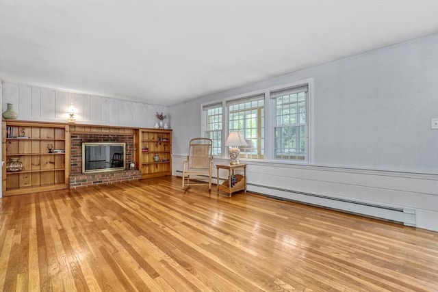7 Burton Ave, Harwich, MA 02671 - living area featuring hardwood / wood-style flooring, a baseboard heating unit, and a fireplace