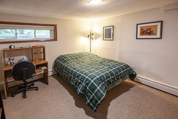 bedroom featuring carpet and a textured ceiling
