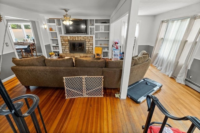 274 Primrose, Fall River, MA 02720 - living area featuring ceiling fan, a fireplace, wood finished floors, a baseboard heating unit, and built in features