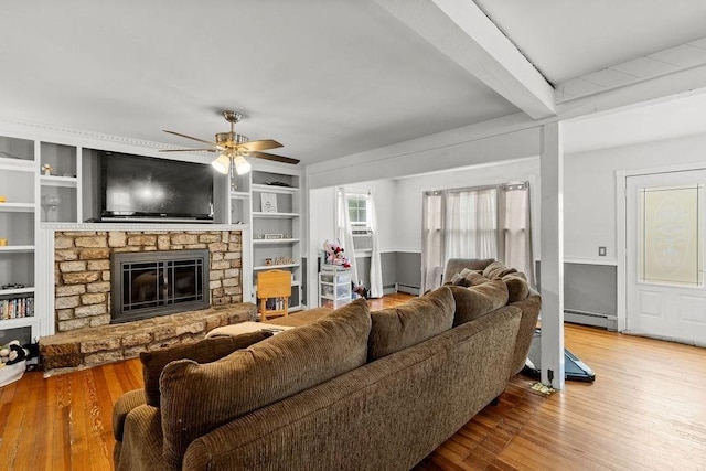 274 Primrose, Fall River, MA 02720 - living room featuring baseboard heating, ceiling fan, wood finished floors, a stone fireplace, and beam ceiling