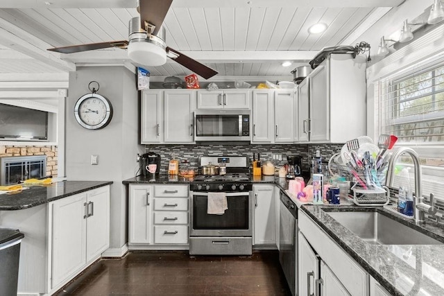 274 Primrose, Fall River, MA 02720 - kitchen with stainless steel appliances, a wooden ceiling with exposed beams, decorative backsplash, ceiling fan, and dark stone counters