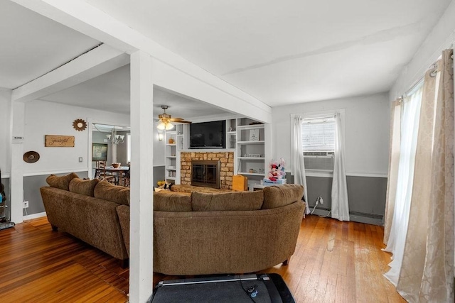 274 Primrose, Fall River, MA 02720 - living room with hardwood / wood-style flooring, ceiling fan, a stone fireplace, cooling unit, and baseboard heating