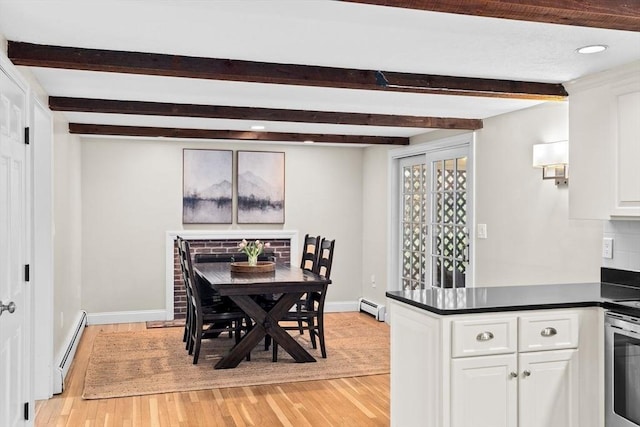 dining room with beamed ceiling, baseboard heating, light wood-style flooring, and baseboards