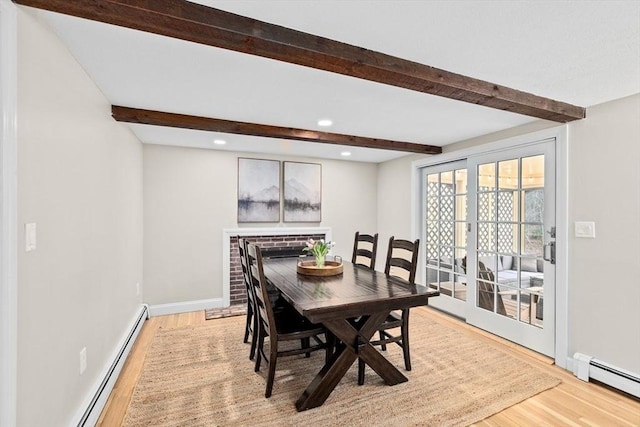 dining room with light wood-style floors, baseboards, beamed ceiling, and baseboard heating