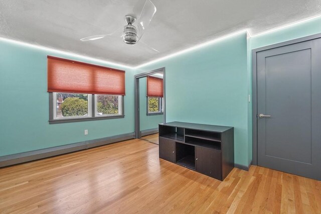 interior space featuring light wood finished floors and ceiling fan