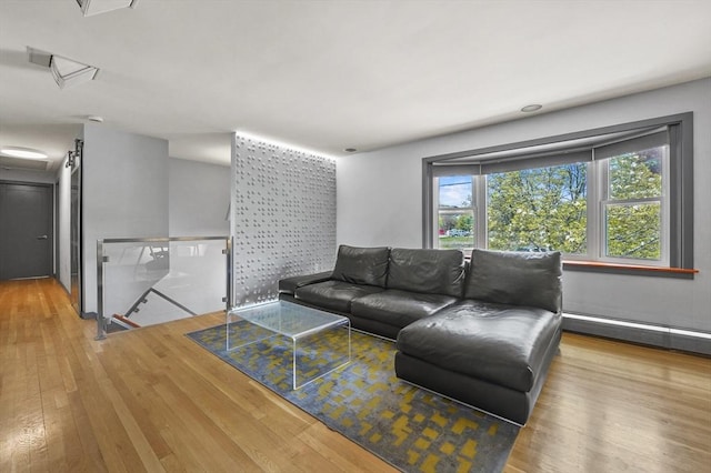 living room with a baseboard radiator and wood finished floors