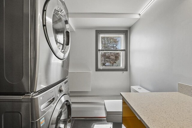 laundry room featuring laundry area and stacked washer / dryer