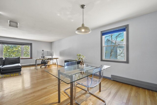 dining area featuring baseboards, visible vents, and light wood-style floors