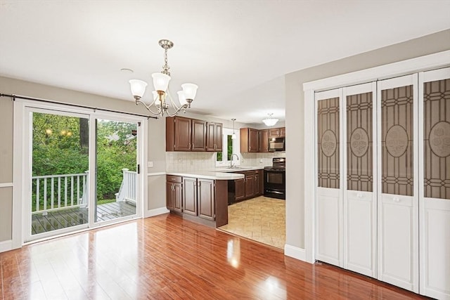 24 Highcrest Park Unit 24, Webster, MA 01570 - kitchen featuring black appliances, light countertops, healthy amount of natural light, and a chandelier