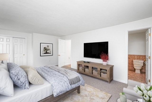 24 Highcrest Park Unit 24, Webster, MA 01570 - carpeted bedroom featuring a closet, baseboards, and connected bathroom