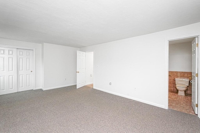 24 Highcrest Park Unit 24, Webster, MA 01570 - unfurnished bedroom featuring carpet floors, baseboards, ensuite bathroom, and a closet