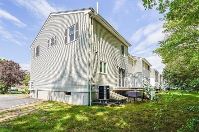 24 Highcrest Park Unit 24, Webster, MA 01570 - view of side of home with central AC unit, a lawn, and a deck