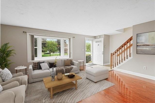 24 Highcrest Park Unit 24, Webster, MA 01570 - living area with wood finished floors, stairway, and baseboards
