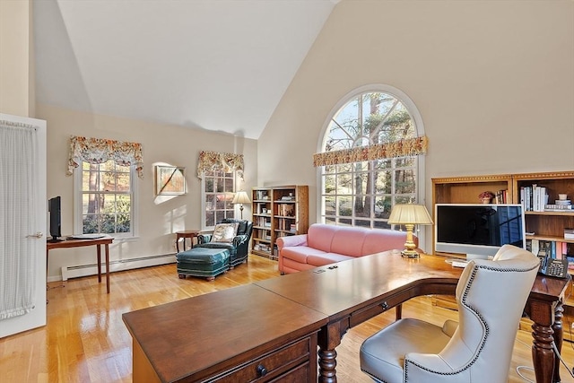 office space featuring hardwood / wood-style floors, high vaulted ceiling, and a baseboard heating unit