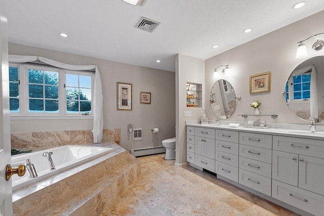 bathroom featuring tiled tub, a baseboard radiator, vanity, and toilet