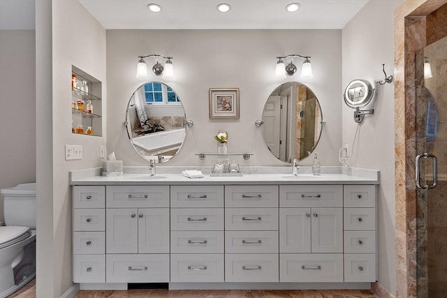 bathroom featuring an enclosed shower, vanity, and toilet