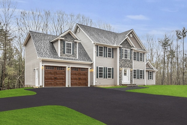 view of front facade with a garage and a front lawn